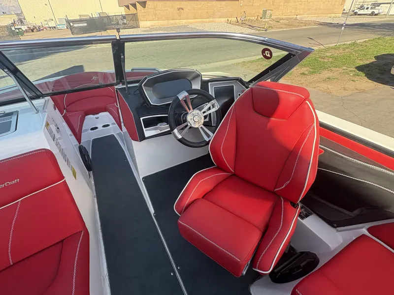 Slide: The Image of 2018 MasterCraft XT23 boat interior with red seats and steering wheel. - 8