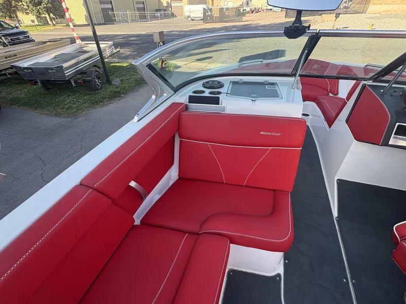Slide: The Image of 2018 MasterCraft XT23 boat interior with red seating and modern dashboard. - 9