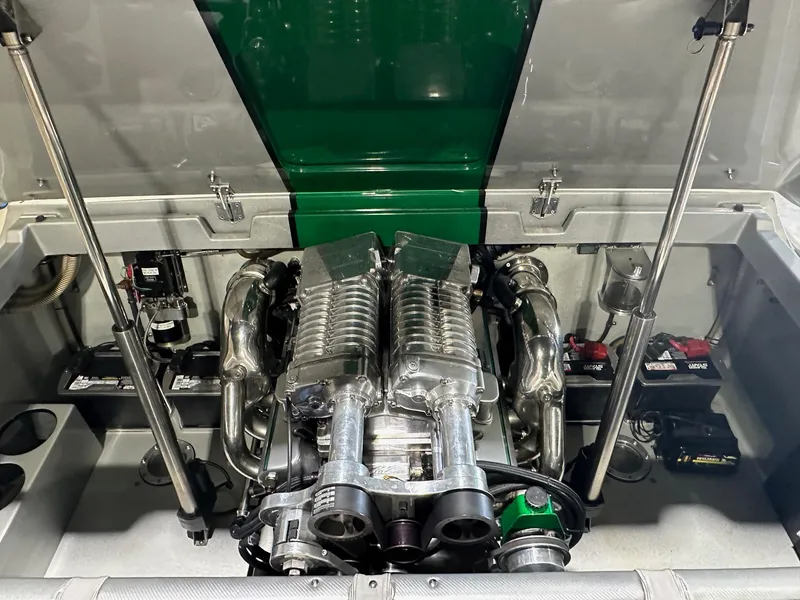 Slide: The Image of Engine compartment of a 2013 Howard 28 SCS boat, featuring a powerful engine setup. - 10