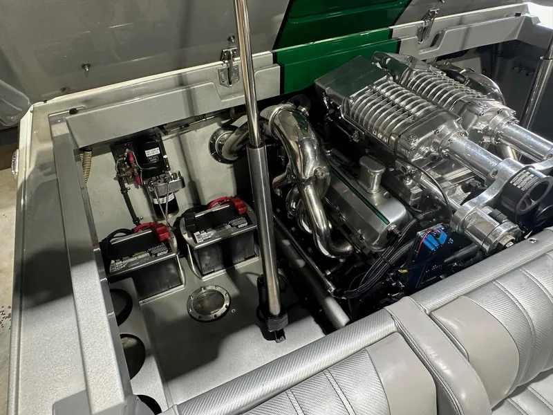Slide: The Image of Engine compartment of a 2013 Howard 28 SCS boat, featuring a powerful engine setup. - 11