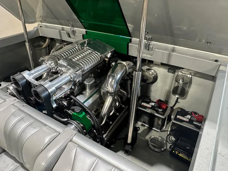 Slide: The Image of Engine compartment of a 2013 Howard 28 SCS boat, showcasing a powerful engine setup. - 12