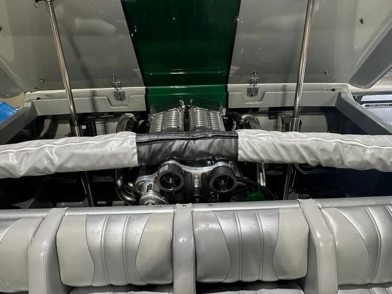 Slide: The Image of Engine compartment of a 2013 Howard 28 SCS boat, showcasing detailed mechanical components. - 13