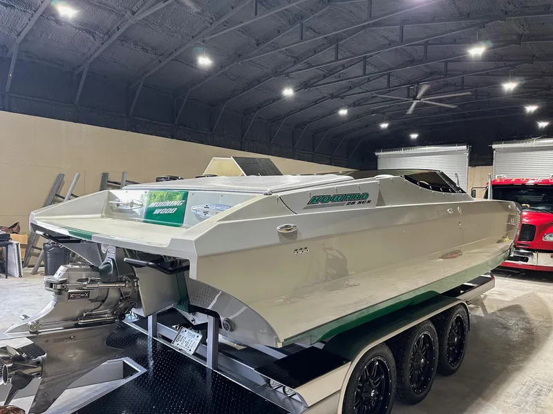 Slide: The Image of 2013 Howard 28 SCS speedboat on trailer in a dimly lit garage. - 5