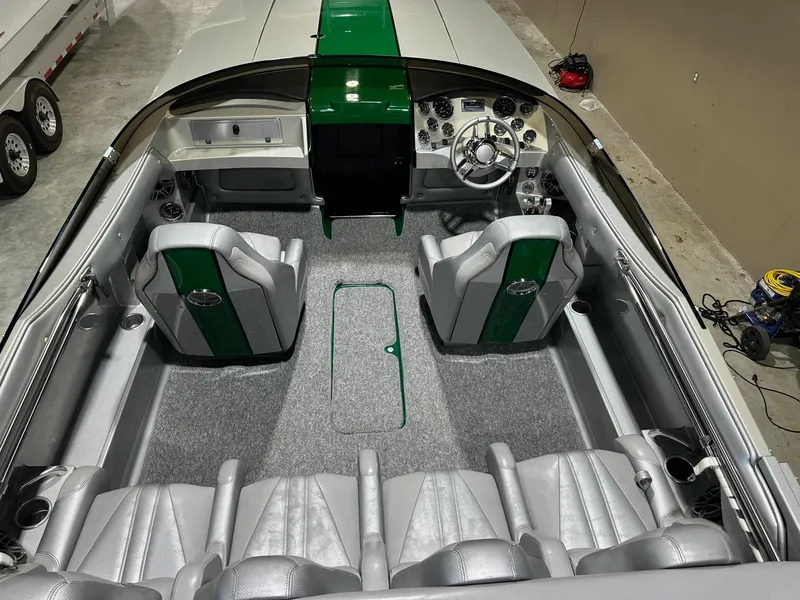 Slide: The Image of Interior of a 2013 Howard 28 SCS boat with green and gray seating. - 7