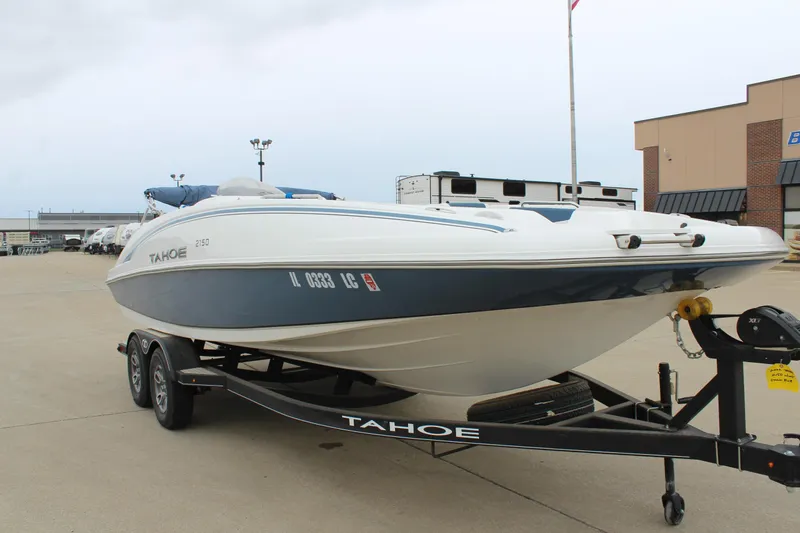 Slide: The Image of 2022 Tahoe 2150 boat on trailer in parking lot, side view. - 1