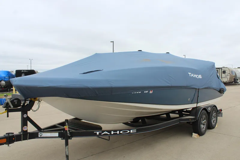 Slide: The Image of 2022 Tahoe 2150 boat covered on trailer, parked outdoors. - 11
