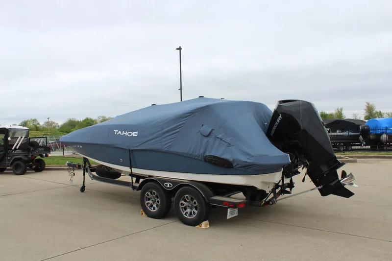 Slide: The Image of 2022 Tahoe 2150 boat covered on trailer, parked outdoors. - 13