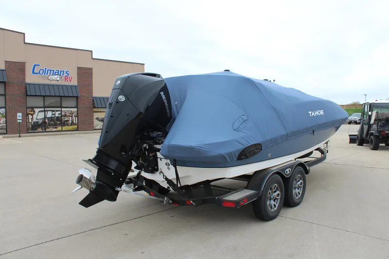 Slide: The Image of 2022 Tahoe 2150 boat on trailer with cover, parked outside Coleman's RV. - 15