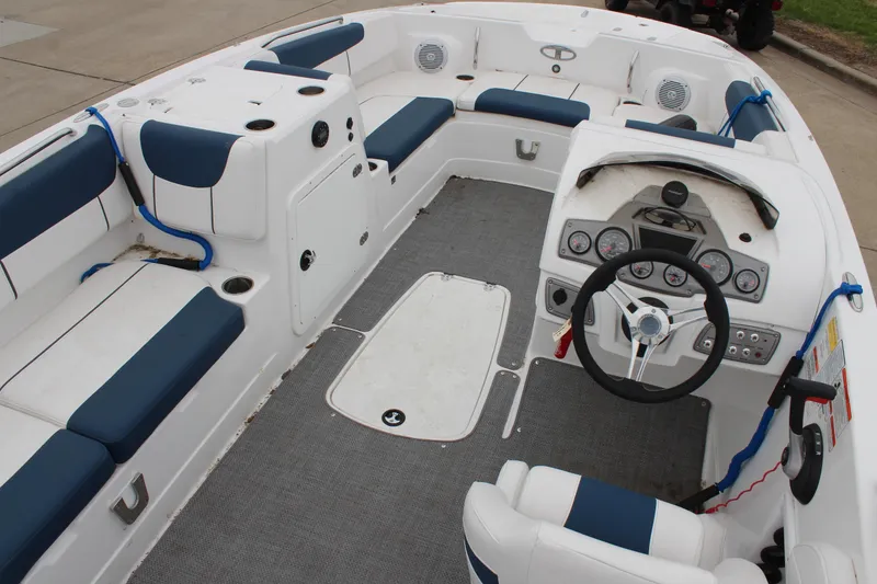 Slide: The Image of 2022 Tahoe 2150 boat interior with seating, steering wheel, and control panel. - 16