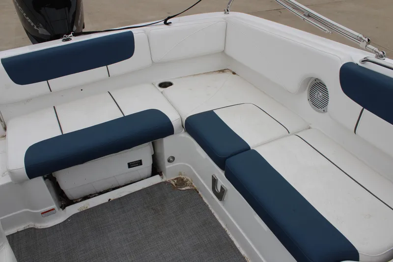 Slide: The Image of 2022 Tahoe 2150 boat interior with blue and white seating arrangement. - 17