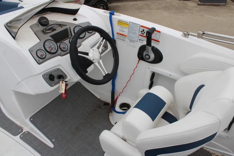 Slide: The Image of 2022 Tahoe 2150 boat cockpit with steering wheel and controls. - 18
