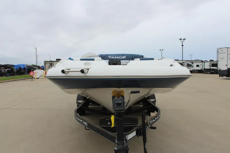 Slide: The Image of 2022 Tahoe 2150 boat on trailer in parking lot, overcast sky. - 2
