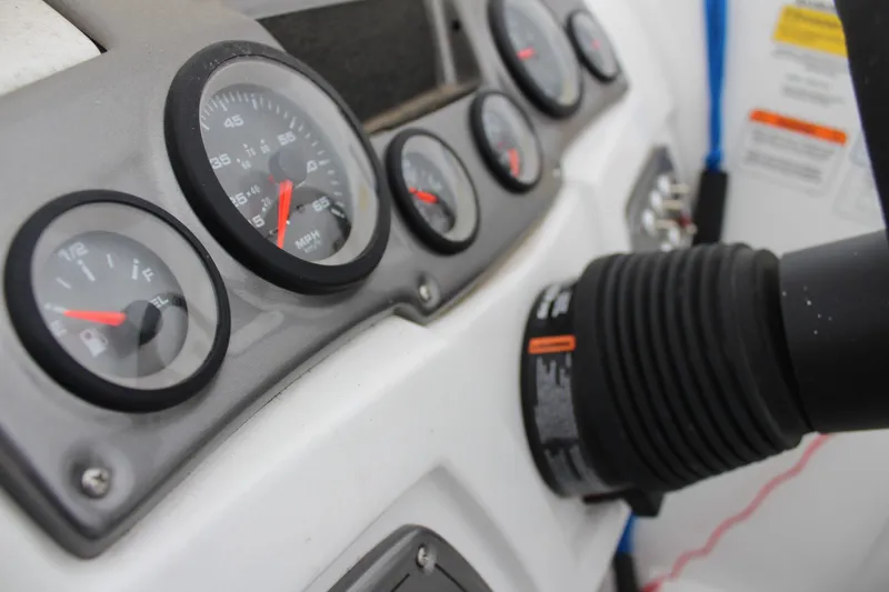 Slide: The Image of Dashboard of a 2022 Tahoe 2150 boat with gauges and controls. - 20