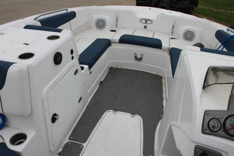 Slide: The Image of 2022 Tahoe 2150 boat interior with blue and white seating, speakers, and control panel. - 21
