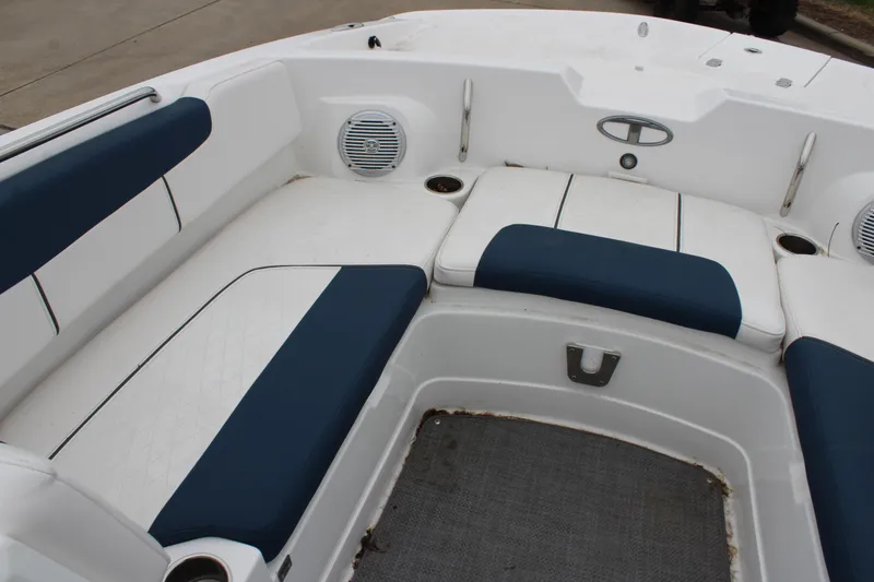 Slide: The Image of 2022 Tahoe 2150 boat interior with blue and white seating and built-in speakers. - 23
