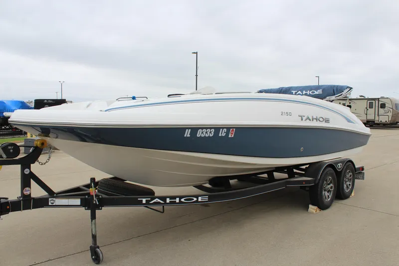 Slide: The Image of 2022 Tahoe 2150 boat on trailer, parked outdoors, side view. - 3