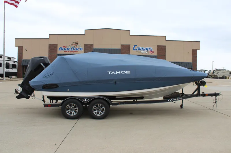 Slide: The Image of 2022 Tahoe 2150 boat with cover on trailer, parked outside dealership. - 8