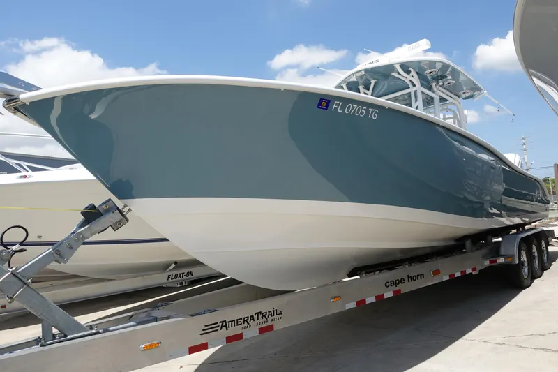 The Image of 2022 Cape Horn 34 XS boat on trailer, side view, under clear blue sky. - 14