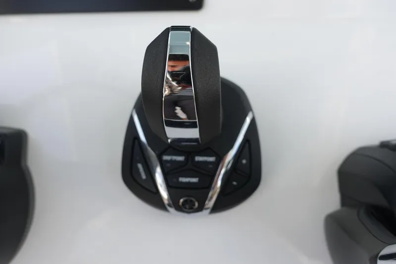 Slide: The Image of 2022 Cape Horn 34 XS boat control lever with buttons on a sleek console. - 18