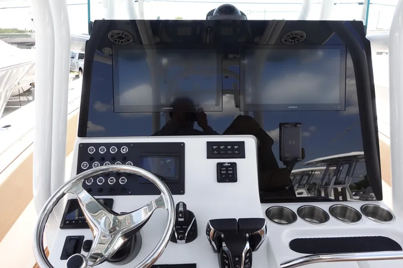 Slide: The Image of 2022 Cape Horn 34 XS boat dashboard with steering wheel and electronic controls. - 16