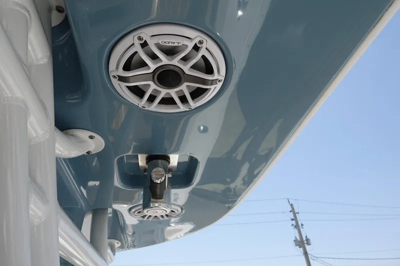 Slide: The Image of 2022 Cape Horn 34 XS boat with mounted speakers and blue canopy. - 21