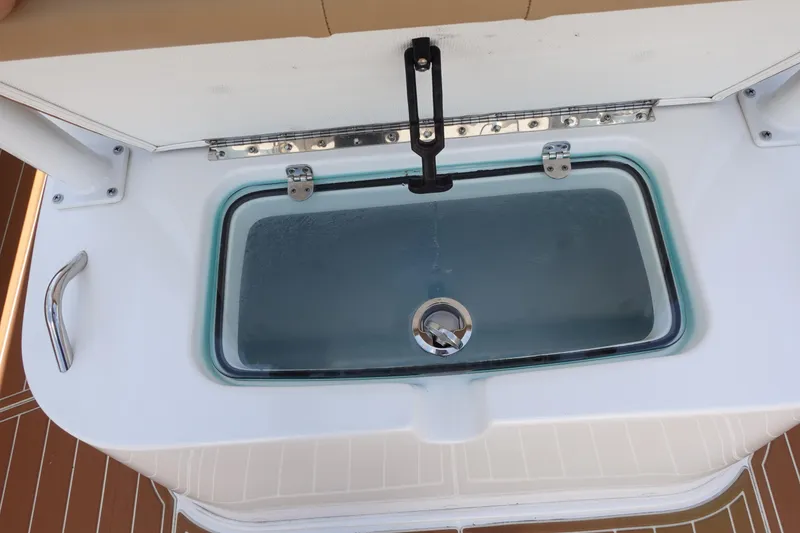 Slide: The Image of Livewell on 2022 Cape Horn 34 XS boat, featuring a secure latch and clear lid. - 35