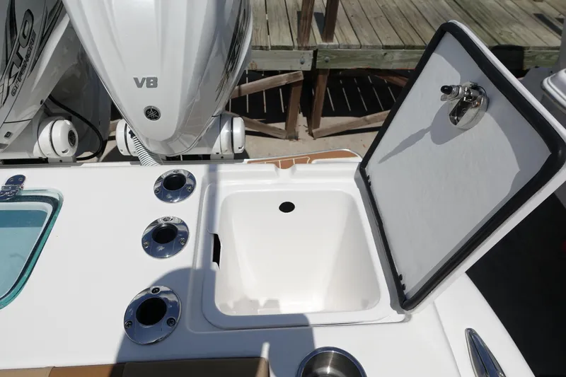 Slide: The Image of 2022 Cape Horn 34 XS boat with open storage compartment and engine details. - 36