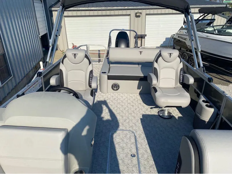Slide: The Image of 2025 Trifecta 24 UL LE pontoon boat interior with gray seating and modern design. - 12
