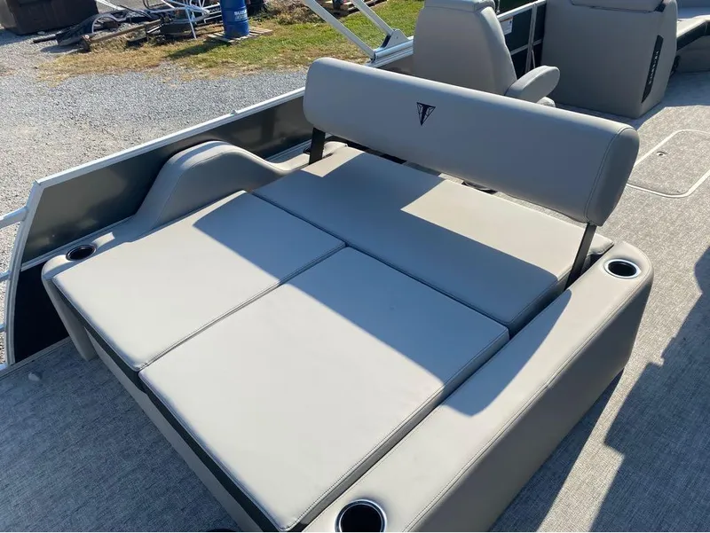 Slide: The Image of 2025 Trifecta 24 UL LE boat with gray cushioned seating and cup holders. - 13