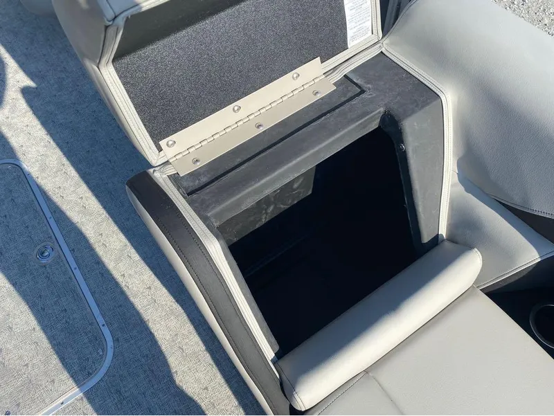 Slide: The Image of Open storage compartment in 2025 Trifecta 24 UL LE boat, featuring cushioned seating. - 48
