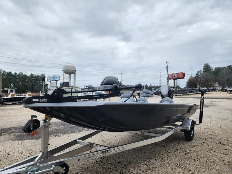 Slide: The Image of 2024 Xpress XP200 Catfish boat on trailer, parked outdoors under cloudy sky. - 0