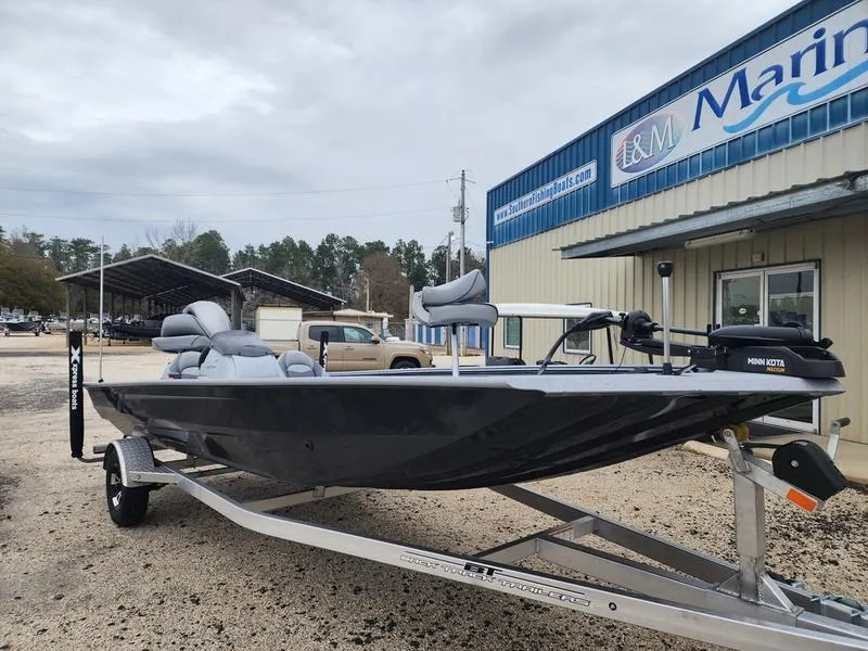 Slide: The Image of 2024 Xpress XP200 Catfish boat on trailer outside marine dealership. - 1