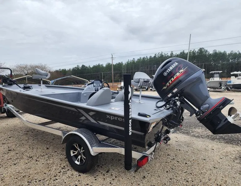 Slide: The Image of 2024 Xpress XP200 Catfish boat with Yamaha engine on trailer, parked outdoors. - 5