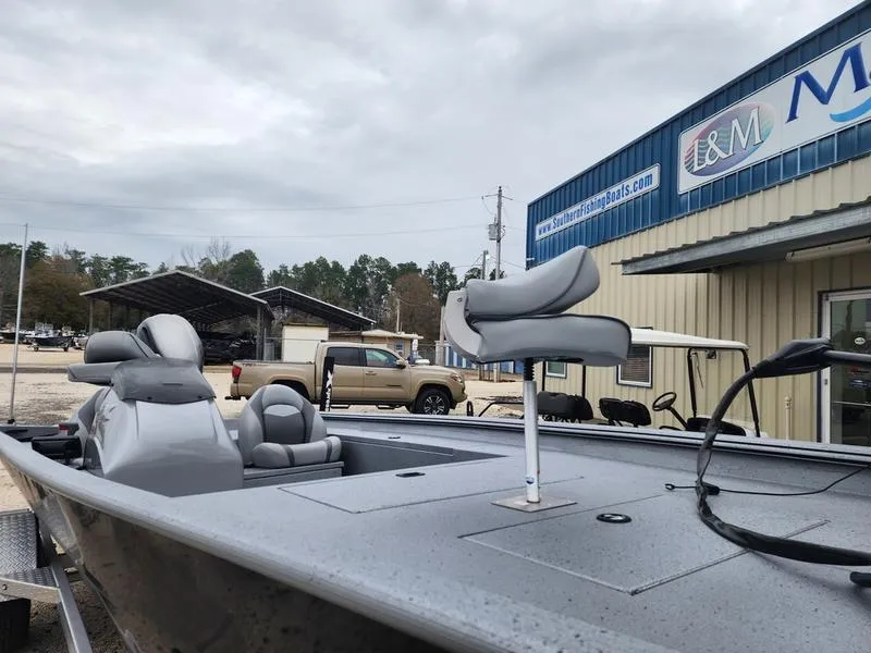 Slide: The Image of 2024 Xpress XP200 Catfish boat with seating, parked outside a dealership. - 6