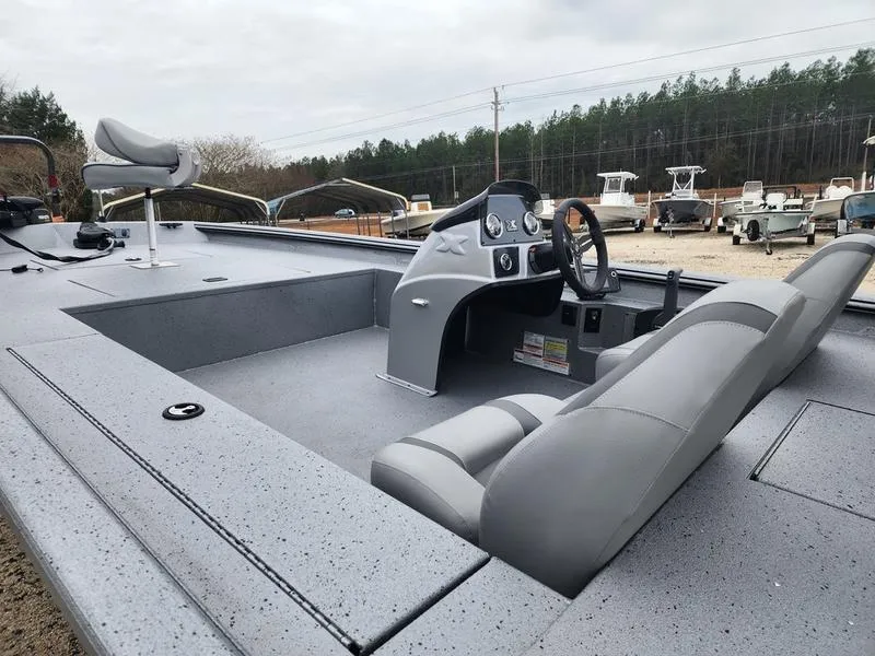 Slide: The Image of 2024 Xpress XP200 Catfish boat with gray interior and steering console, parked outdoors. - 9