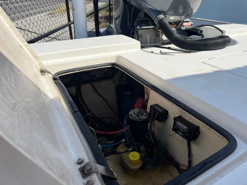 Slide: The Image of Open compartment of a 2008 Pathfinder 2200 Tournament Edition boat showing internal wiring and components. - 11