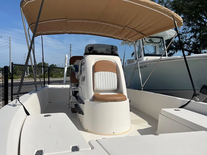 Slide: The Image of 2008 Pathfinder 2200 Tournament Edition boat with canopy, featuring a central console and seating. - 2
