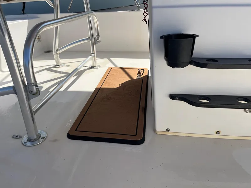 Slide: The Image of 2008 Pathfinder 2200 Tournament Edition boat deck with mat and cup holder. - 4