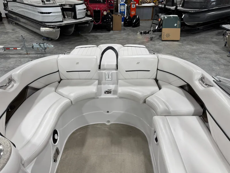 Slide: The Image of 2009 Four Winns H-260 boat interior with white seating in a showroom. - 12