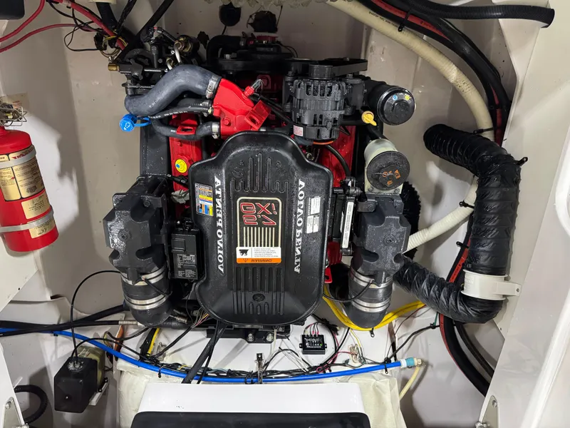 Slide: The Image of Engine compartment of a 2009 Four Winns H-260 boat, featuring a Volvo Penta motor. - 15