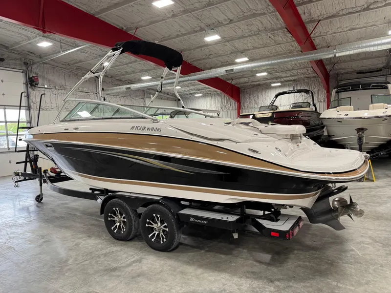 Slide: The Image of 2009 Four Winns H-260 boat on trailer in indoor showroom. - 3
