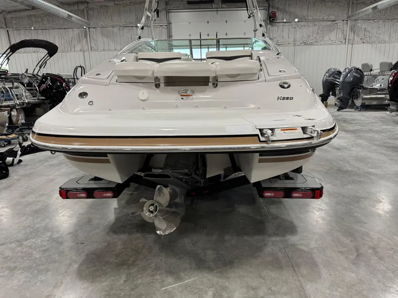 Slide: The Image of 2009 Four Winns H-260 boat in a showroom, rear view with propeller visible. - 5