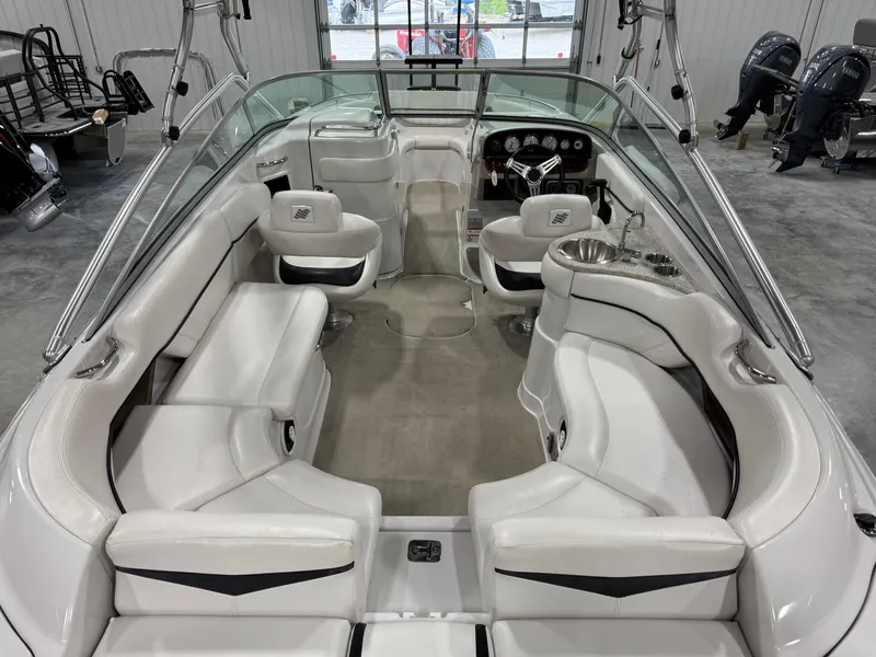 Slide: The Image of 2009 Four Winns H-260 boat interior with white seating and modern dashboard. - 6