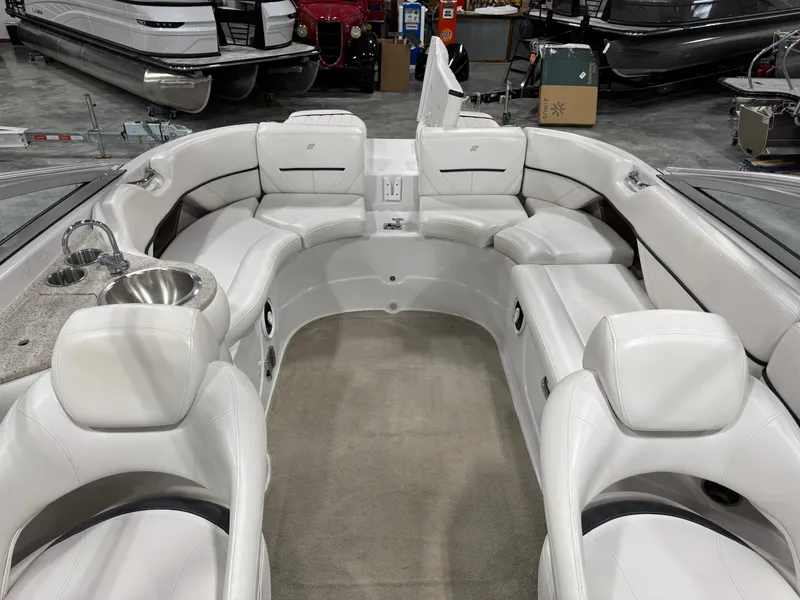 Slide: The Image of 2009 Four Winns H-260 boat interior with white seating and a built-in sink. - 7