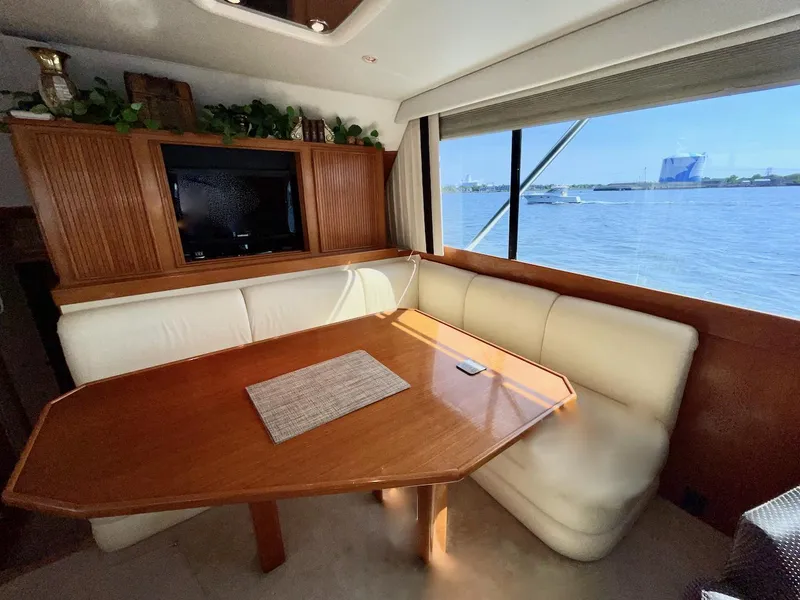 Slide: The Image of Luxurious 1997 Post 50 Convertible yacht interior with dining area and scenic ocean view. - 10