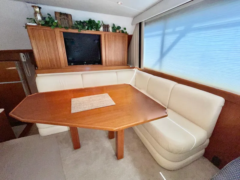 Slide: The Image of Luxurious 1997 Post 50 Convertible yacht interior with elegant dining area and plush seating. - 11