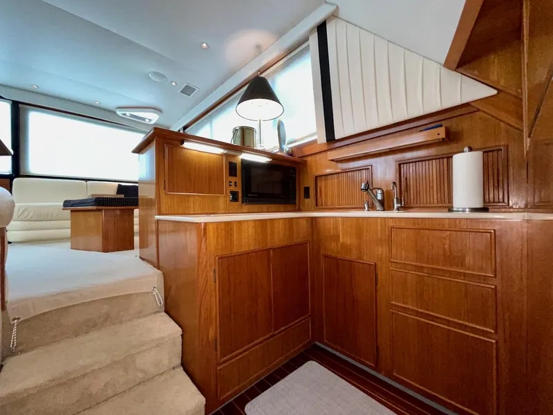 Slide: The Image of Luxurious wooden interior of a 1997 Post 50 Convertible yacht kitchen. - 13