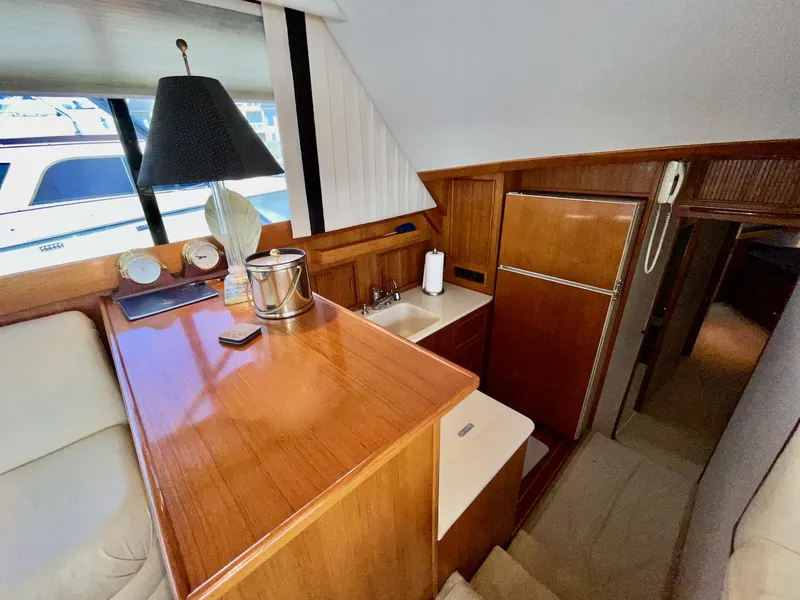 Slide: The Image of Interior of a 1997 Post 50 Convertible yacht with wooden cabinetry and compact kitchen area. - 14