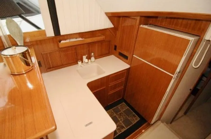 Slide: The Image of 1997 Post 50 Convertible yacht kitchen with wooden cabinetry and modern appliances. - 15