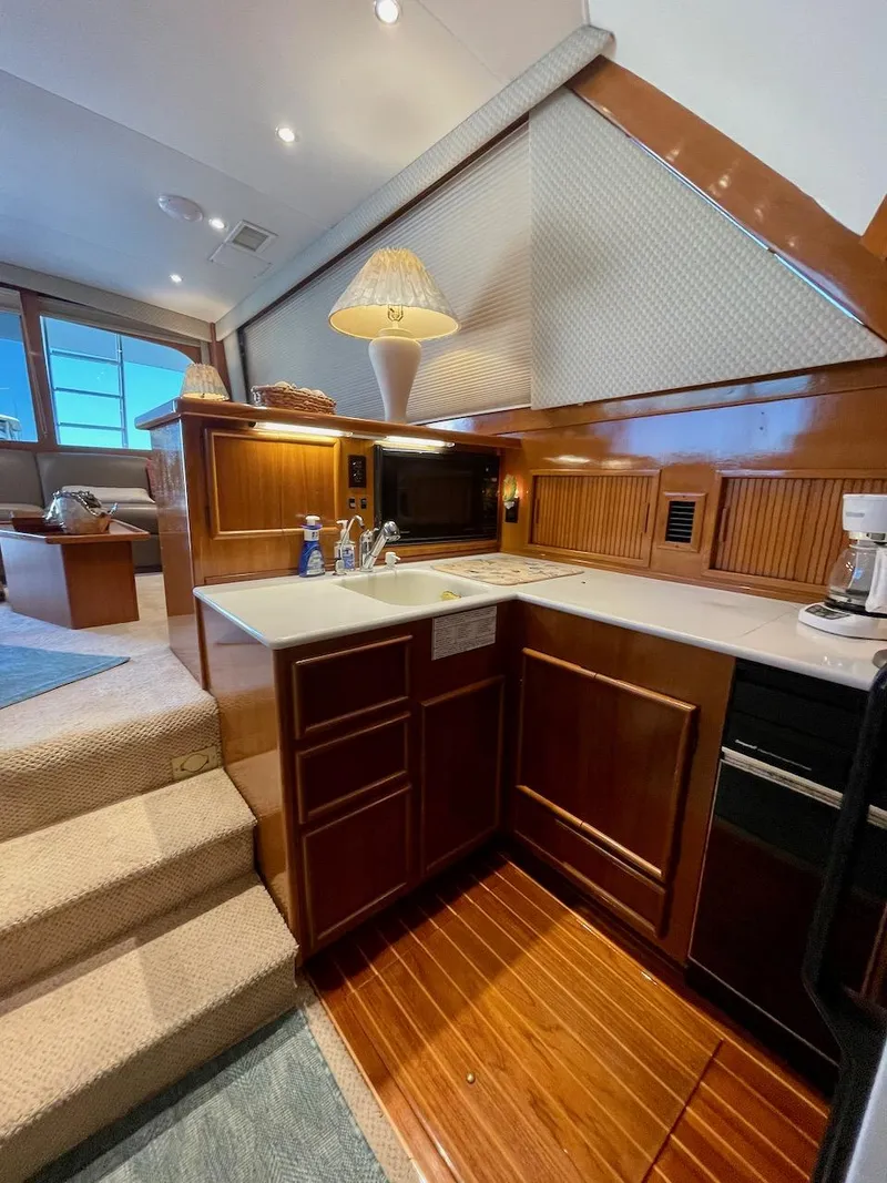 Slide: The Image of Luxurious 1997 Post 50 Convertible yacht interior with modern kitchen and cozy seating area. - 16